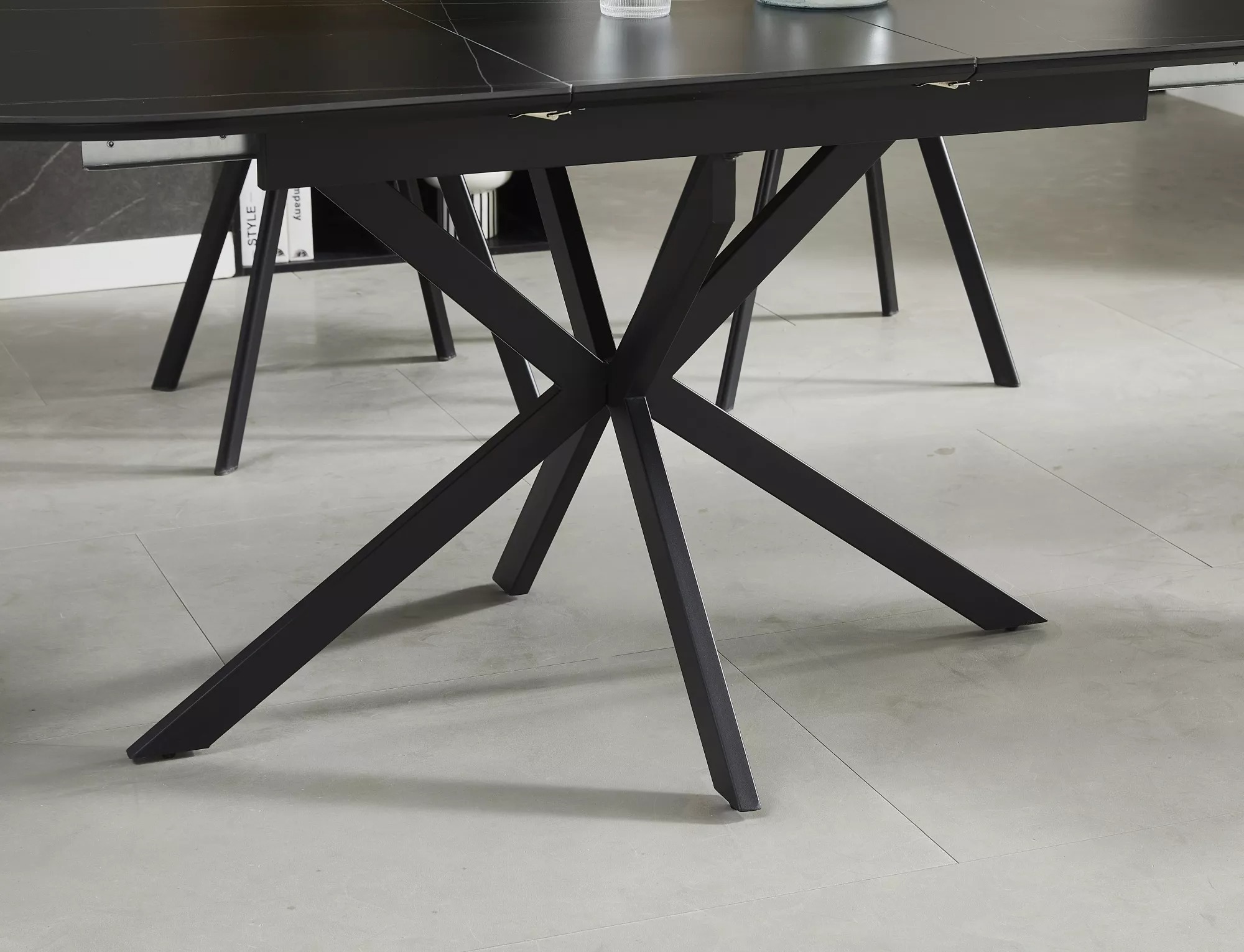Gaston dining table with contemporary crossed-leg matt black metal base