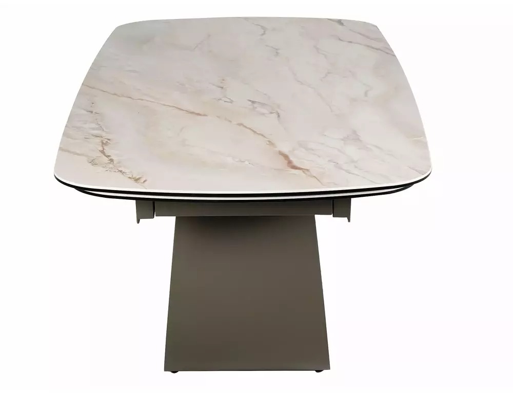 Side view of Casablanca extending dining table with curved metal base and beige ceramic top